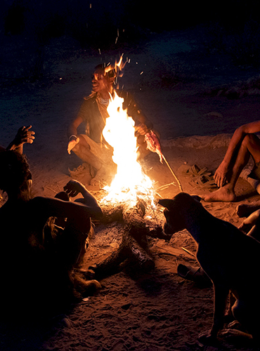 Hadzabe around the fire before the hunt